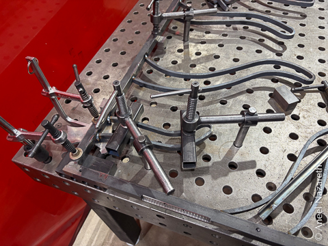 A bunch of clamps hold both the frame and one of the tentacles to the fixture table. The frame is actually spaced 1" above the table with spacers so that the welds are not against the table itself